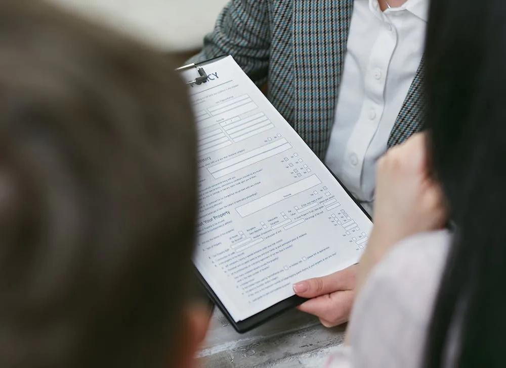 Business owner and adviser reviewing a credit application and terms of trade for credit